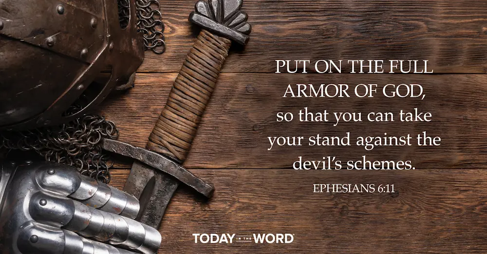 Today's daily devotional Bible verse: Ephesians 6:11 Put on the full armor of God, so that you can take your stand against the devil's schemes. | Knights armor and sword on a wooden table