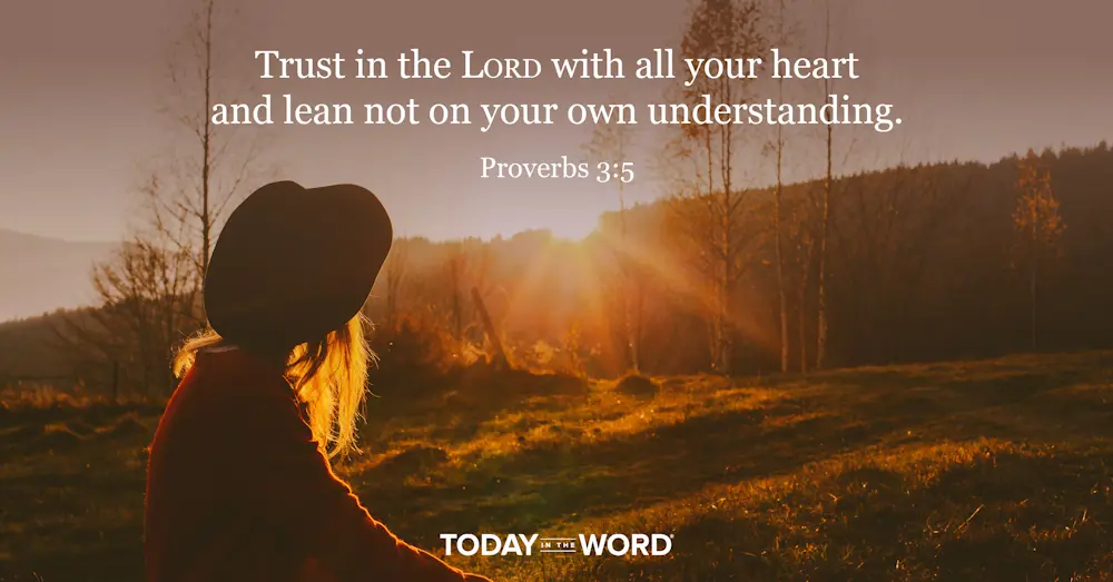 Today's daily devotional Bible verse: Proverbs 3:5 Trust in the LORD with all your heart and lean not on your own understanding. | A woman watching the sunset over the woods.